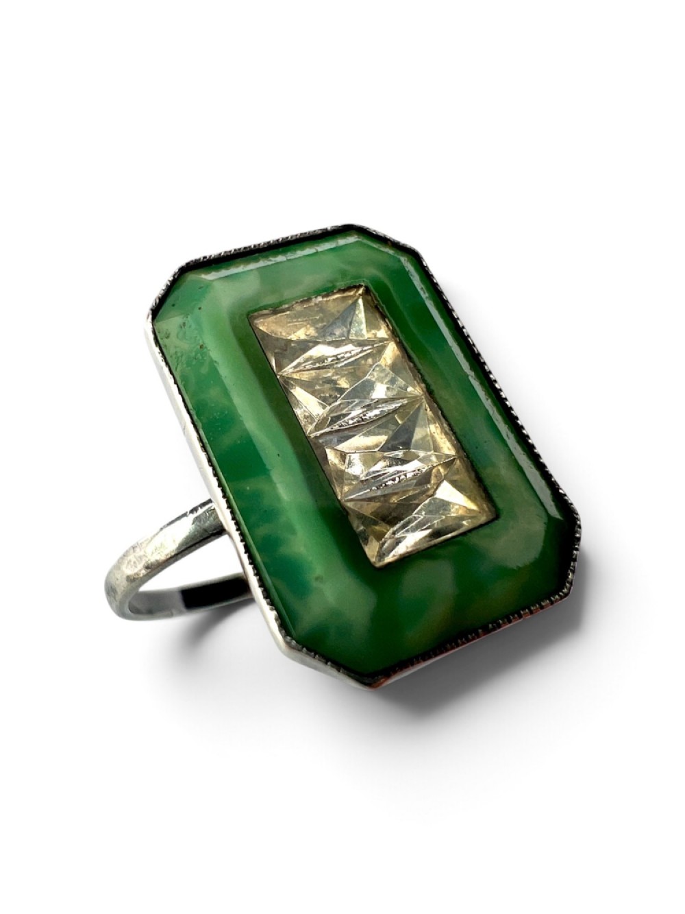 An Art Deco silver jewellery set featuring a rectangular ring and matching drop earrings inset with green glass plaques and clear step-cut paste stones. View V
