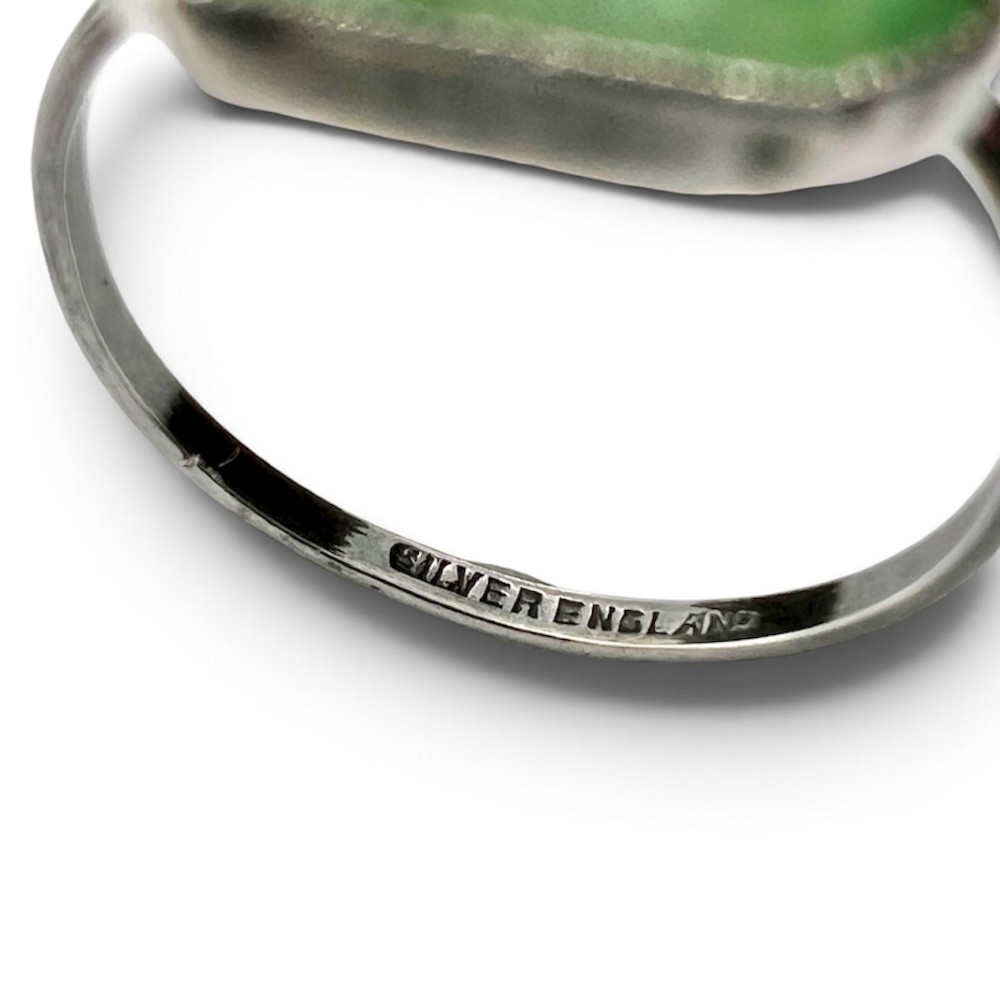 An Art Deco silver jewellery set featuring a rectangular ring and matching drop earrings inset with green glass plaques and clear step-cut paste stones. View VII