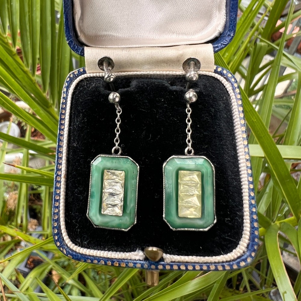 An Art Deco silver jewellery set featuring a rectangular ring and matching drop earrings inset with green glass plaques and clear step-cut paste stones. View VIII