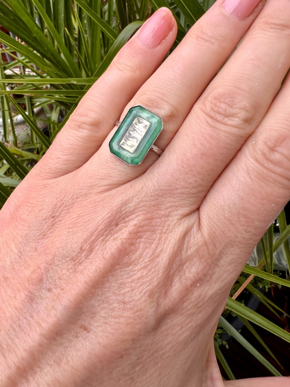 An Art Deco silver jewellery set featuring a rectangular ring and matching drop earrings inset with green glass plaques and clear step-cut paste stones. View IX
