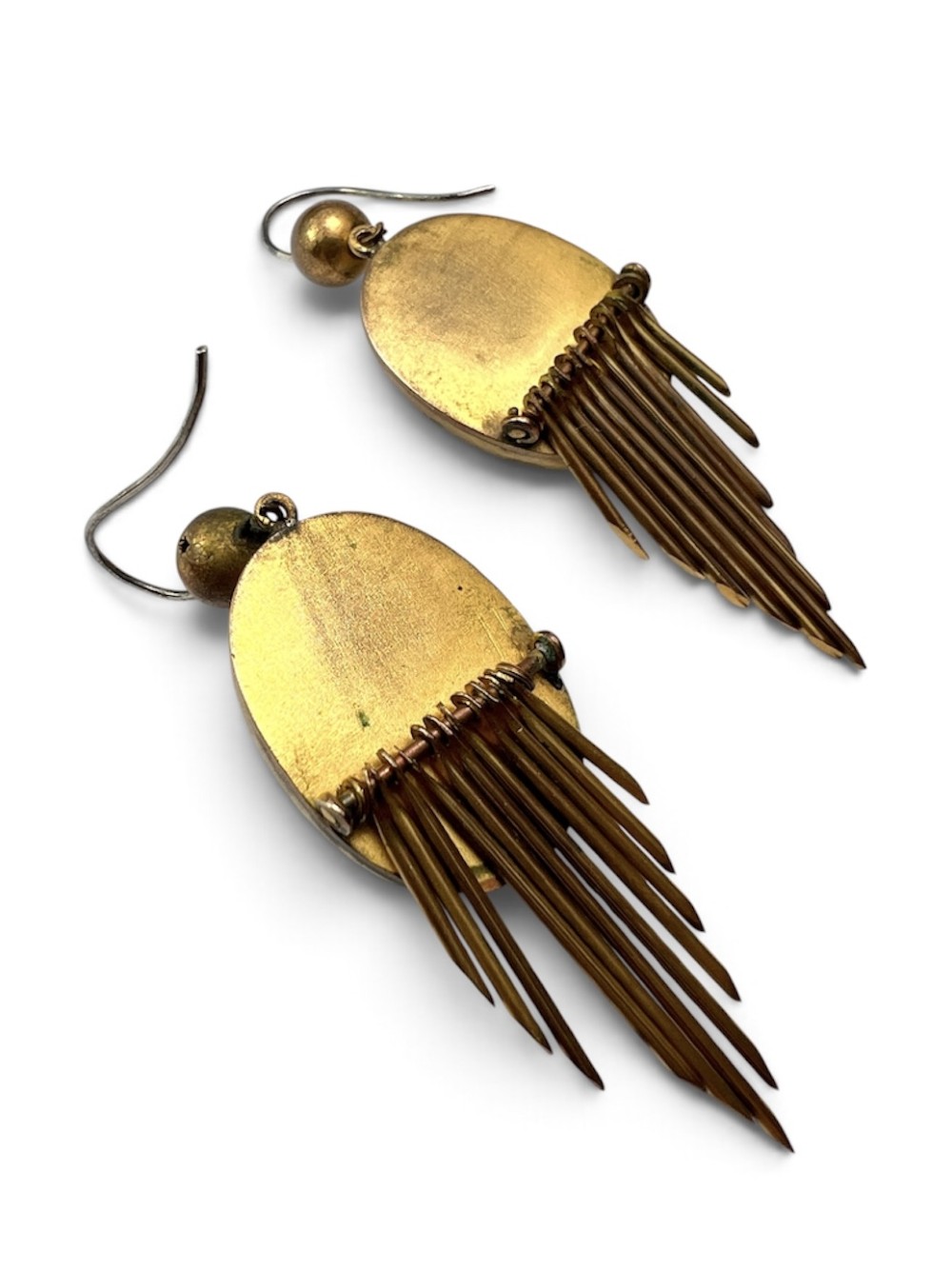 A pair of Victorian drop earrings featuring oval bullseye agate cabochons set in gold frames with graduating metallic fringe spikes below. View V