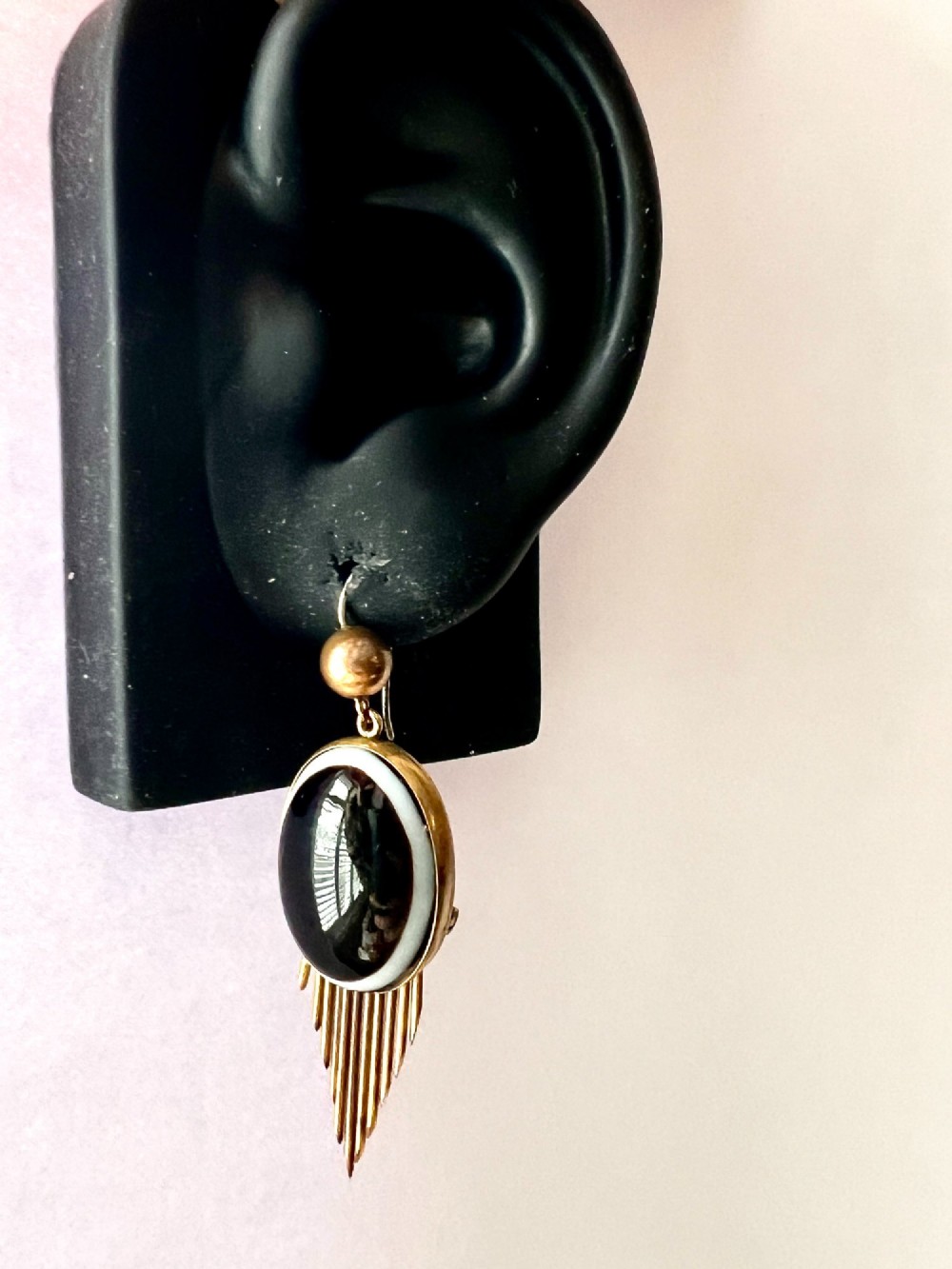 A pair of Victorian drop earrings featuring oval bullseye agate cabochons set in gold frames with graduating metallic fringe spikes below. View VI