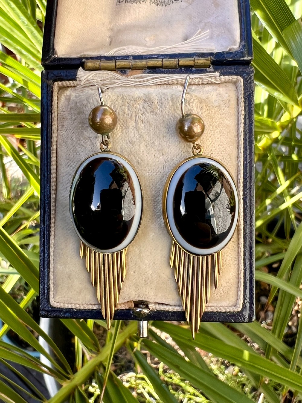 A pair of Victorian drop earrings featuring oval bullseye agate cabochons set in gold frames with graduating metallic fringe spikes below. View IX