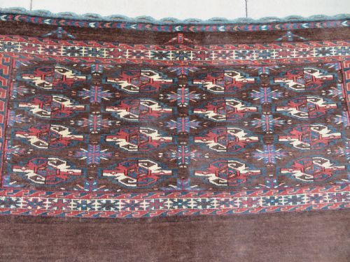 fig 2. A rectangular hand-woven Yomut Turkmen wool chuval bag face featuring sixteen repeating central guls framed by geometric borders and a solid dark brown lower elem skirt.