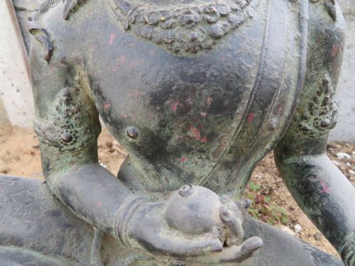 fig 1. A dark bronze sculpture of a seated Bodhisattva Avalokitesvara featuring an ornate crown, beaded jewellery, and a double lotus pedestal base.