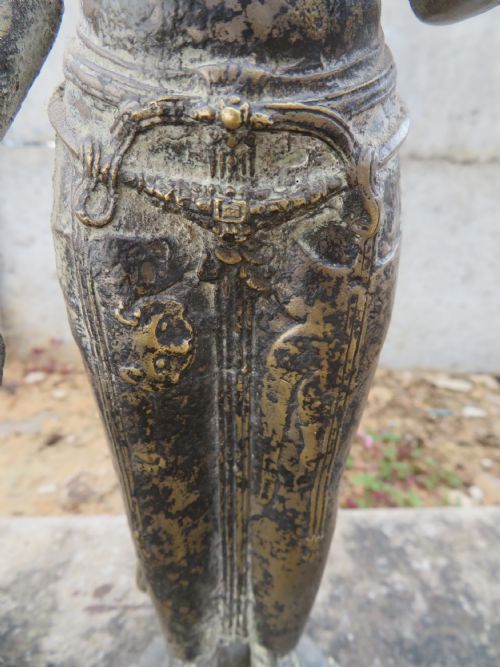 fig 1. A standing four-armed copper alloy figure of the Hindu deity Shiva on a lotus pedestal with an aged patina.