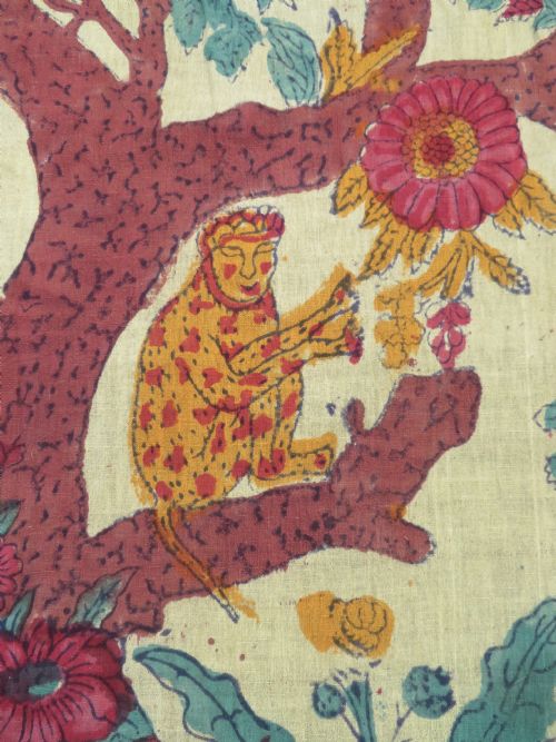 fig 2. An antique 19th-century yellow cotton palampore textile featuring a centrally printed Tree of Life with birds, animals, and a pink floral border.
