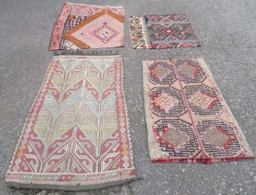 fig 1. A group of four individual hand-woven Turkish kilim mats featuring vibrant geometric patterns, diamond medallions, and zig-zag borders.