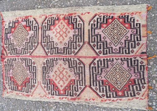fig 2. A group of four individual hand-woven Turkish kilim mats featuring vibrant geometric patterns, diamond medallions, and zig-zag borders.