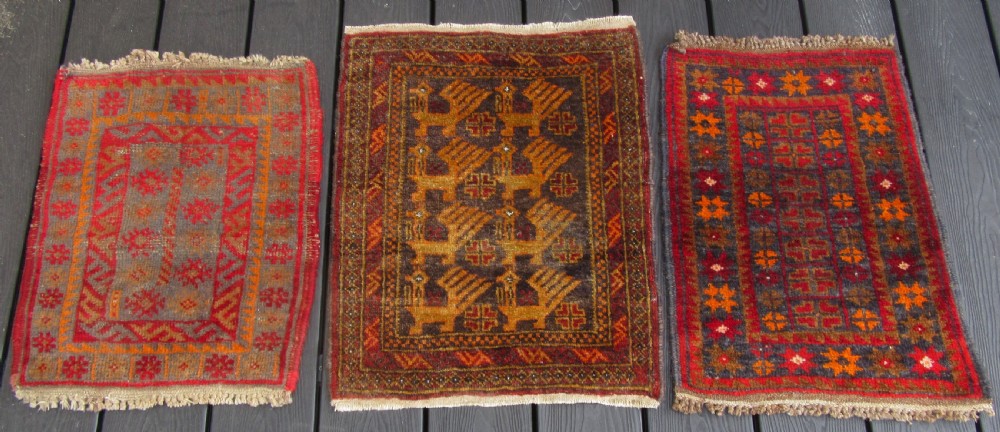 A GROUP OF THREE SMALL OLD BALUCH SCATTER RUGS. GREAT FOR SCATTERING OVER LARGER RUG