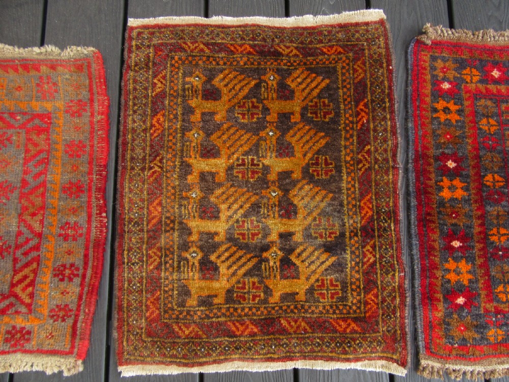 A GROUP OF THREE SMALL OLD BALUCH SCATTER RUGS. GREAT FOR SCATTERING OVER LARGER RUG View II