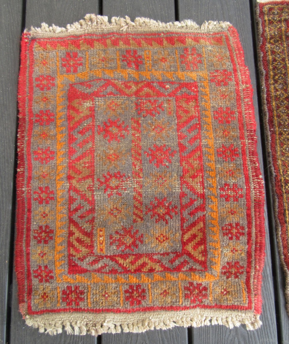 A GROUP OF THREE SMALL OLD BALUCH SCATTER RUGS. GREAT FOR SCATTERING OVER LARGER RUG View III
