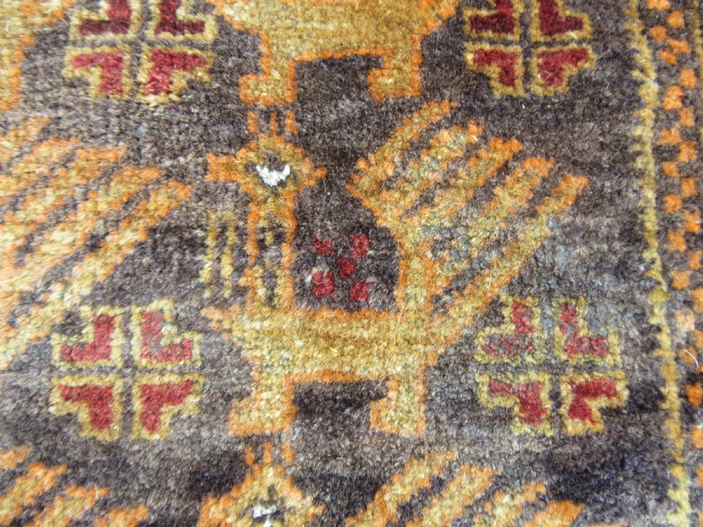 A GROUP OF THREE SMALL OLD BALUCH SCATTER RUGS. GREAT FOR SCATTERING OVER LARGER RUG View V