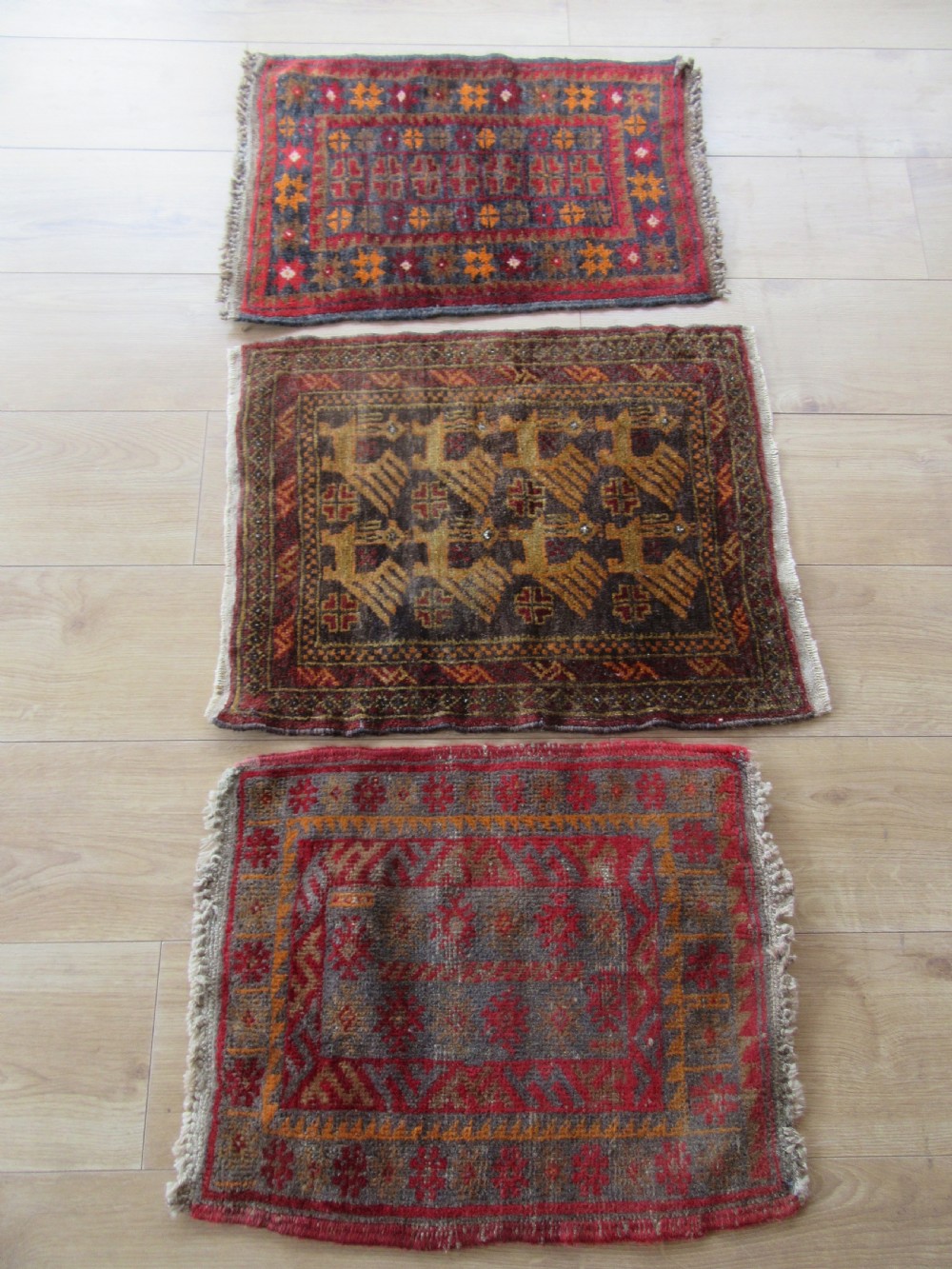 A GROUP OF THREE SMALL OLD BALUCH SCATTER RUGS. GREAT FOR SCATTERING OVER LARGER RUG View XV