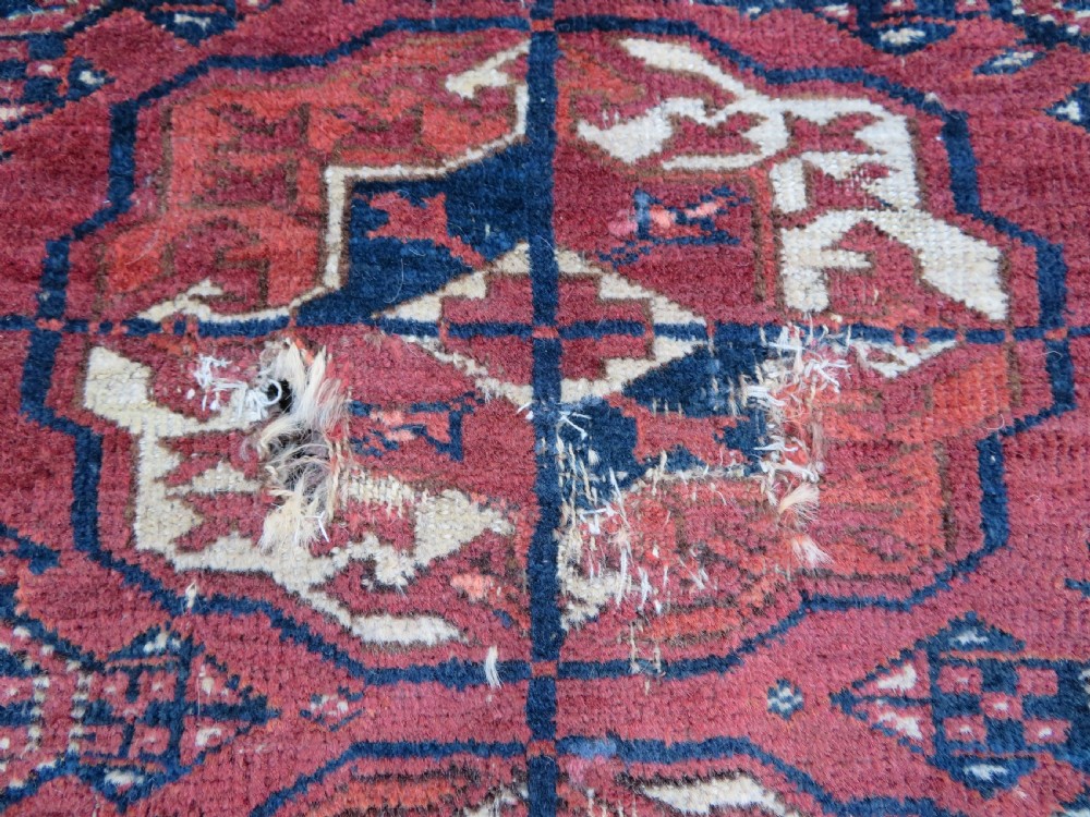 An antique Tekke Turkmen main carpet and matching runner featuring traditional repeating gul motifs in deep red, navy blue, and ivory hand-woven wool. View VIII