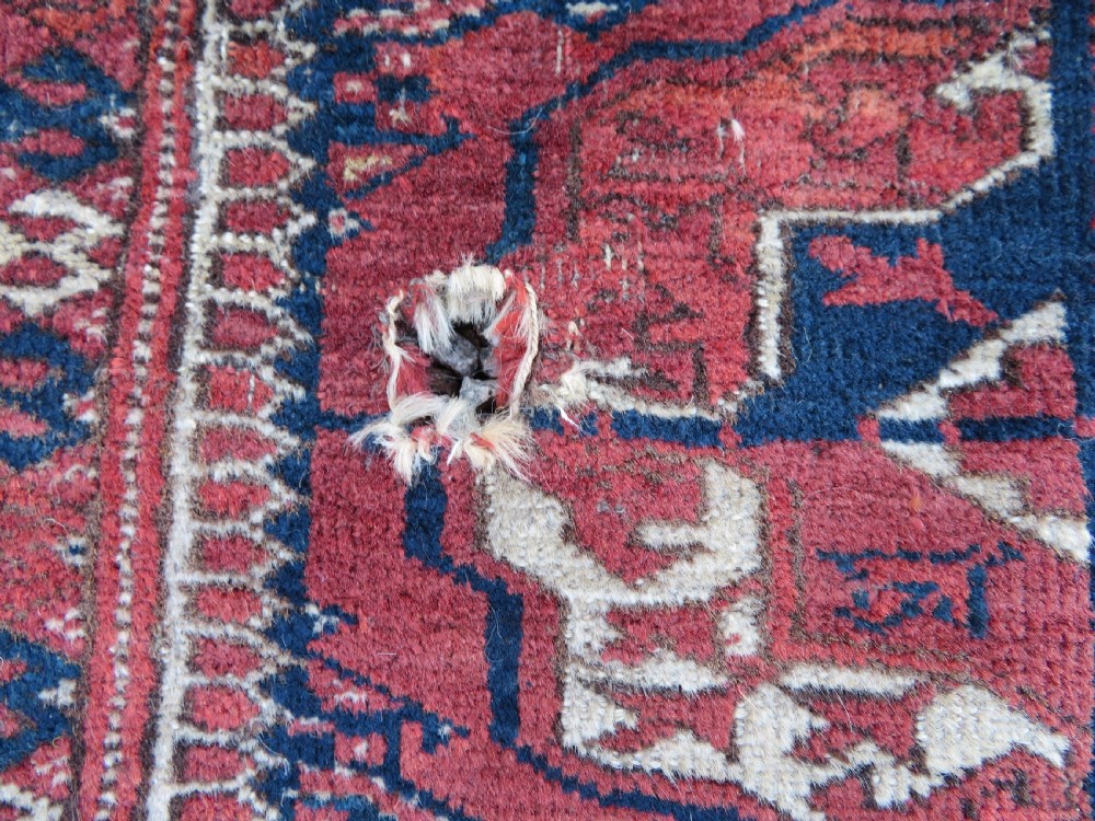 An antique Tekke Turkmen main carpet and matching runner featuring traditional repeating gul motifs in deep red, navy blue, and ivory hand-woven wool. View IX