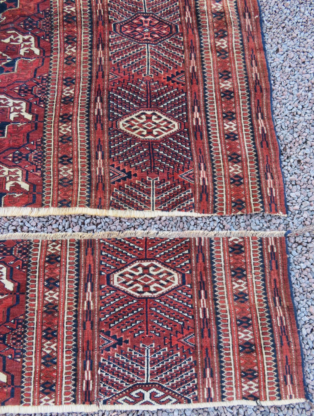An antique Tekke Turkmen main carpet and matching runner featuring traditional repeating gul motifs in deep red, navy blue, and ivory hand-woven wool. View XIII