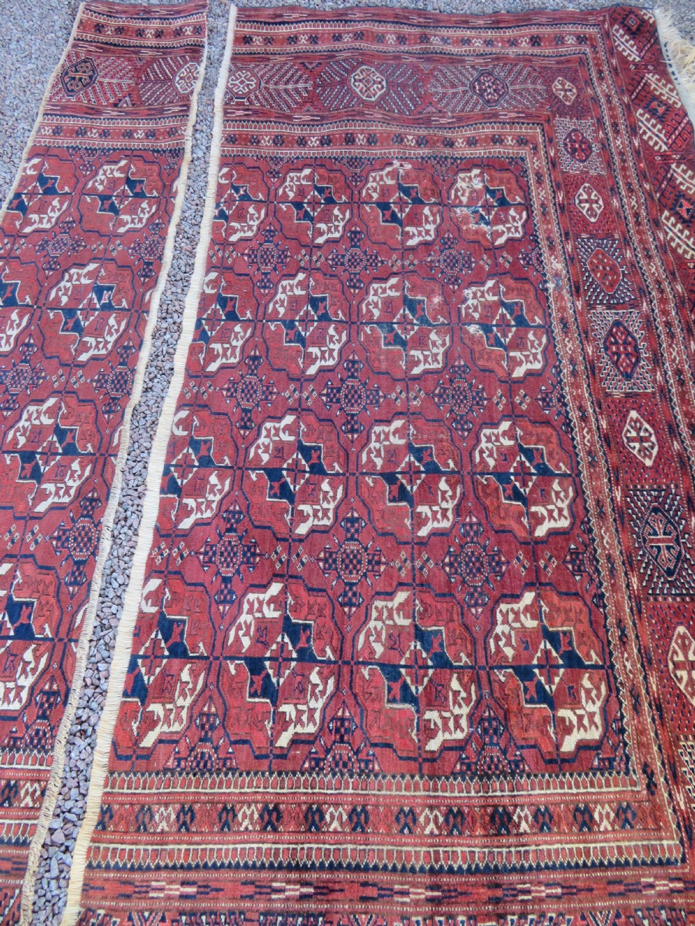 An antique Tekke Turkmen main carpet and matching runner featuring traditional repeating gul motifs in deep red, navy blue, and ivory hand-woven wool. View XVIII