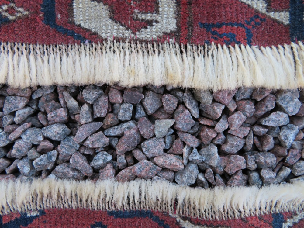 An antique Tekke Turkmen main carpet and matching runner featuring traditional repeating gul motifs in deep red, navy blue, and ivory hand-woven wool. View XIX