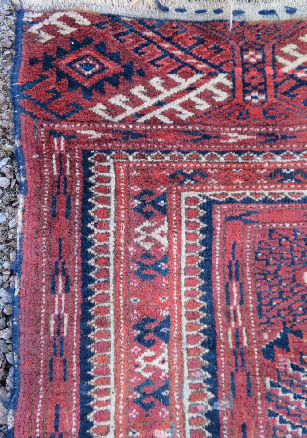 An antique Tekke Turkmen main carpet and matching runner featuring traditional repeating gul motifs in deep red, navy blue, and ivory hand-woven wool. View XXV