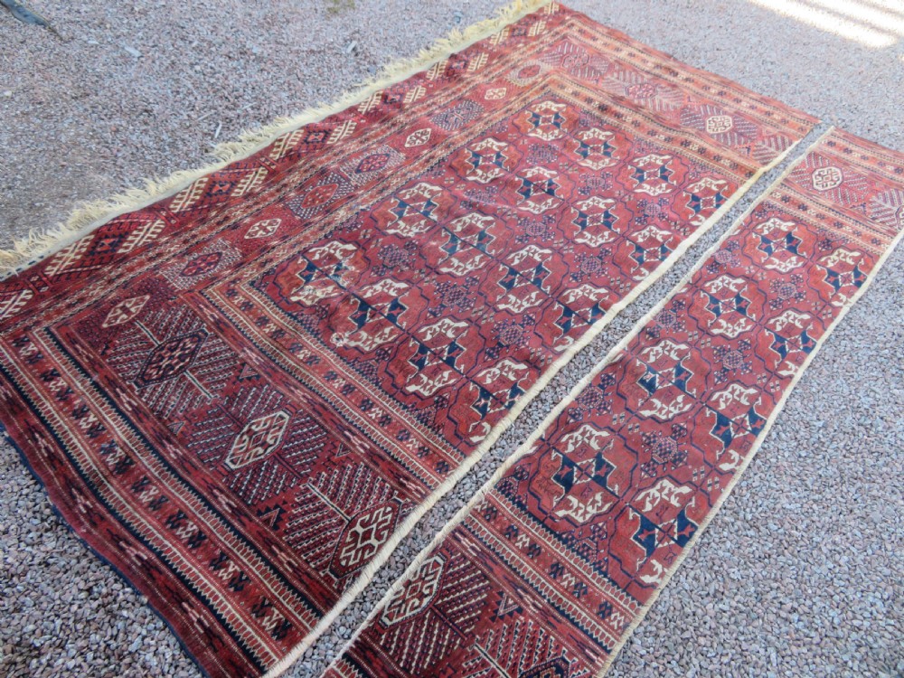 An antique Tekke Turkmen main carpet and matching runner featuring traditional repeating gul motifs in deep red, navy blue, and ivory hand-woven wool. View XXVI