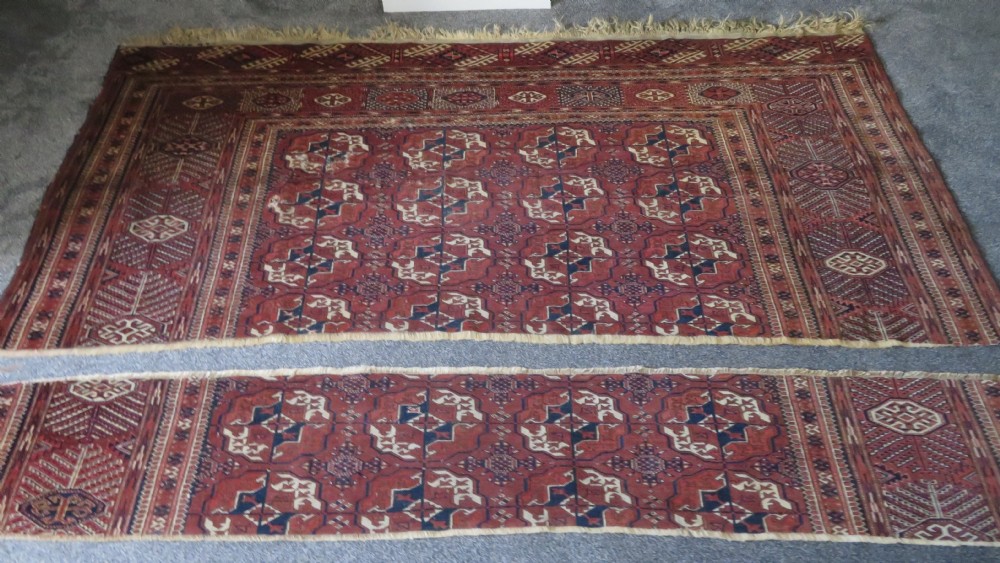 An antique Tekke Turkmen main carpet and matching runner featuring traditional repeating gul motifs in deep red, navy blue, and ivory hand-woven wool. View XXVII