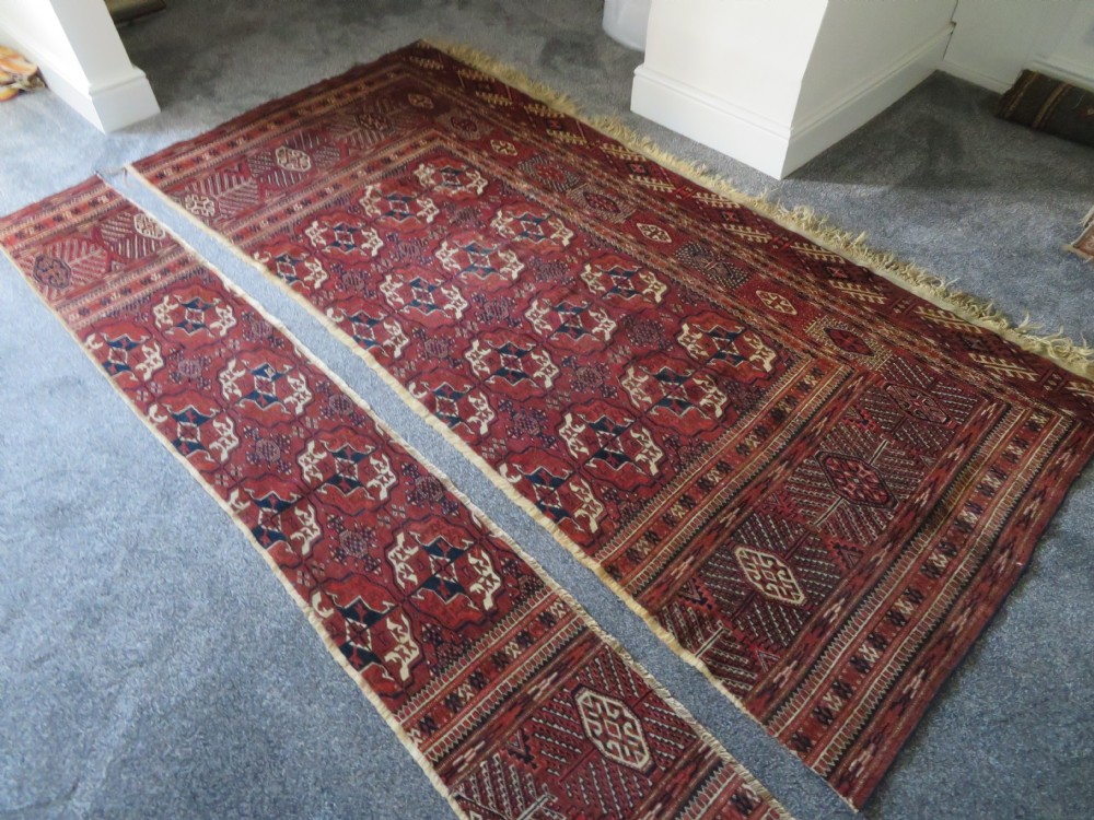 An antique Tekke Turkmen main carpet and matching runner featuring traditional repeating gul motifs in deep red, navy blue, and ivory hand-woven wool. View XXVIII