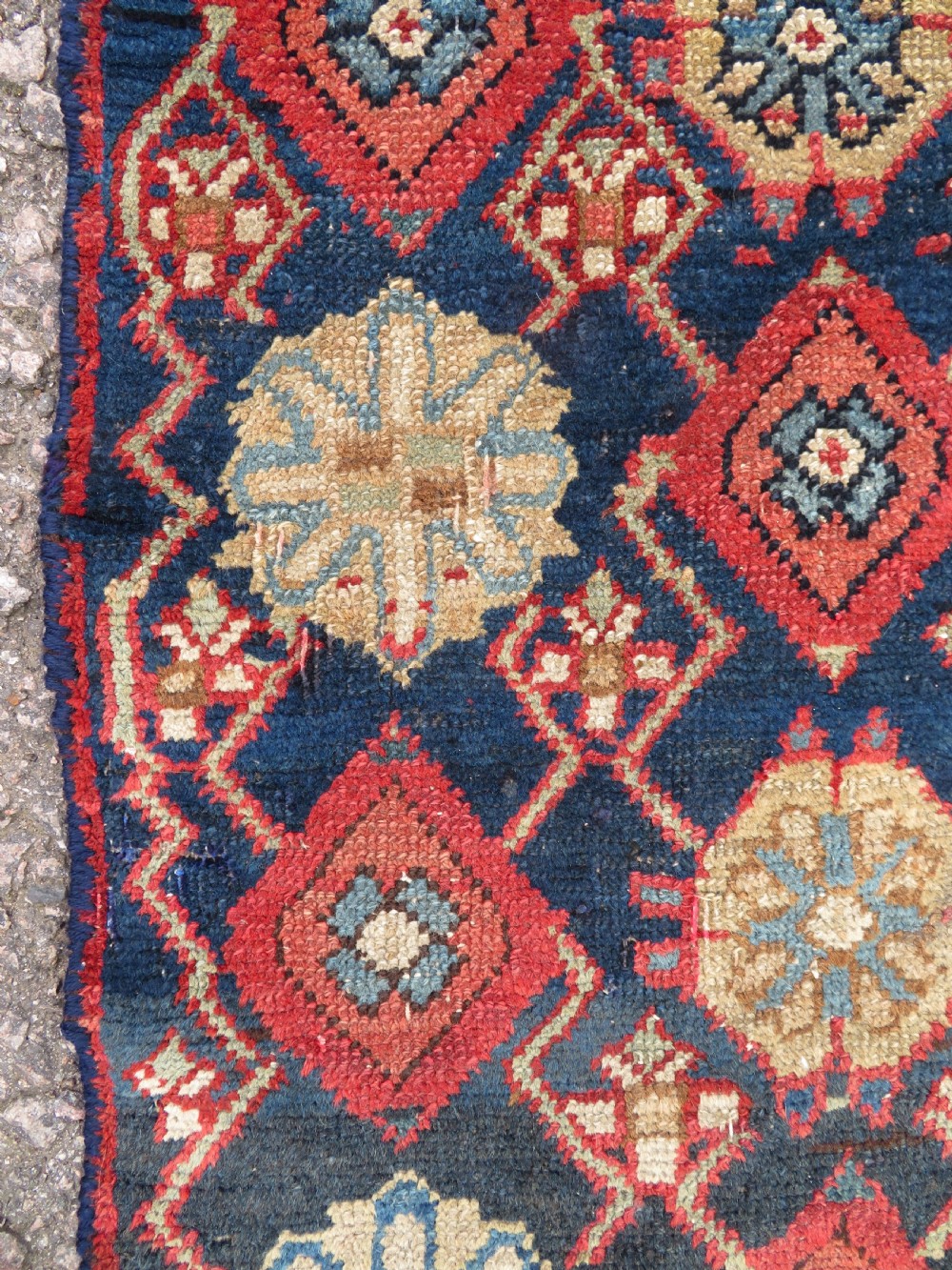 A long, narrow hand-knotted wool runner featuring a repeating geometric Mina Khana floral lattice pattern in navy blue, terracotta red, and cream tones. View XVIII