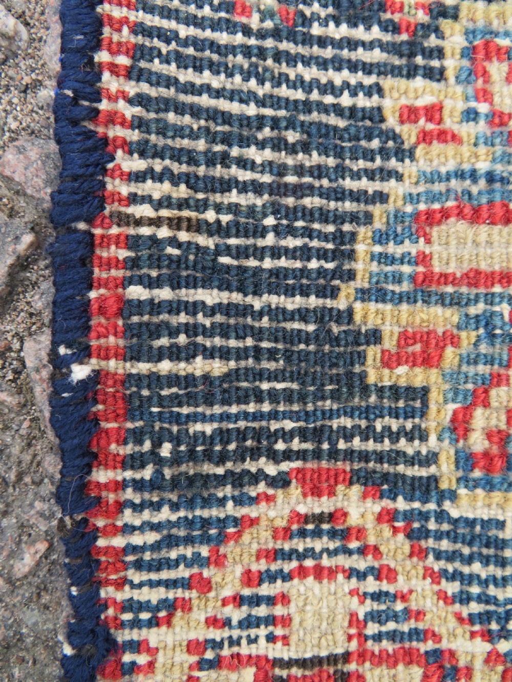 A long, narrow hand-knotted wool runner featuring a repeating geometric Mina Khana floral lattice pattern in navy blue, terracotta red, and cream tones. View XXII