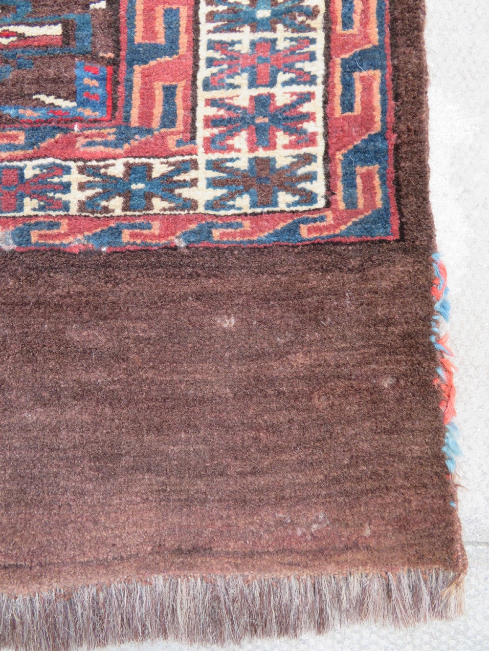 A rectangular hand-woven Yomut Turkmen wool chuval bag face featuring sixteen repeating central guls framed by geometric borders and a solid dark brown lower elem skirt. View VIII