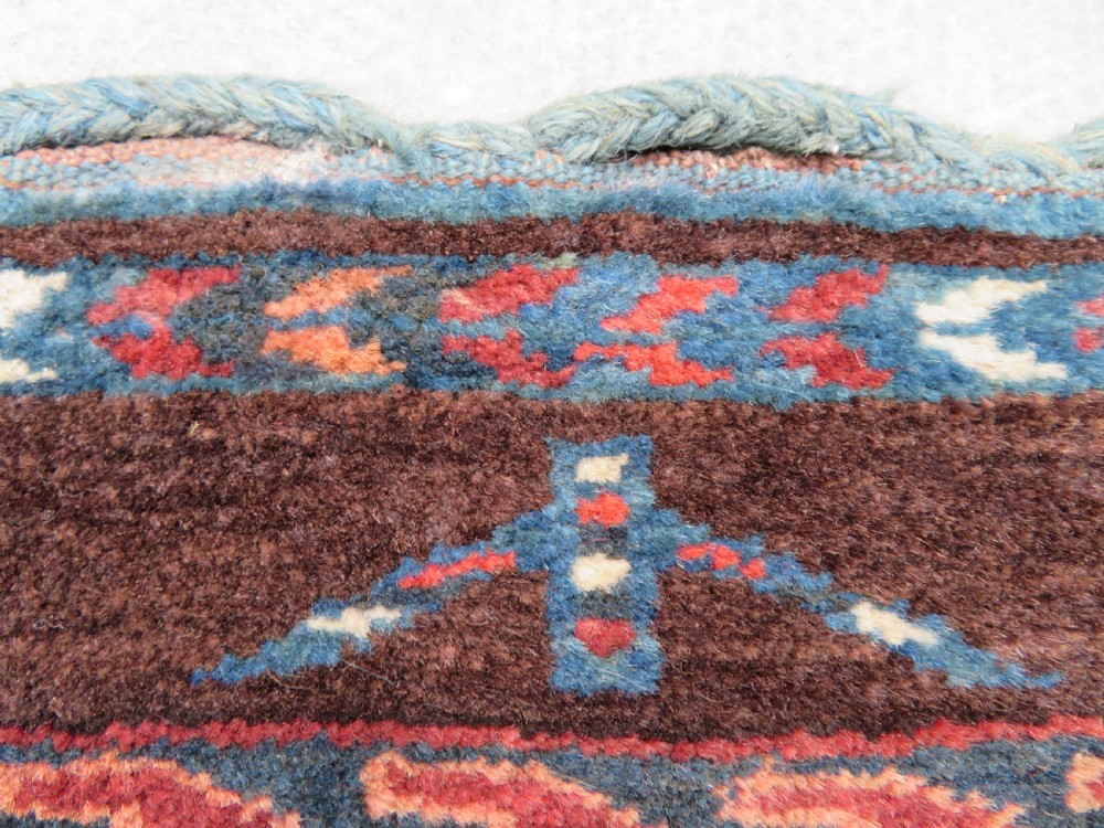 A rectangular hand-woven Yomut Turkmen wool chuval bag face featuring sixteen repeating central guls framed by geometric borders and a solid dark brown lower elem skirt. View X