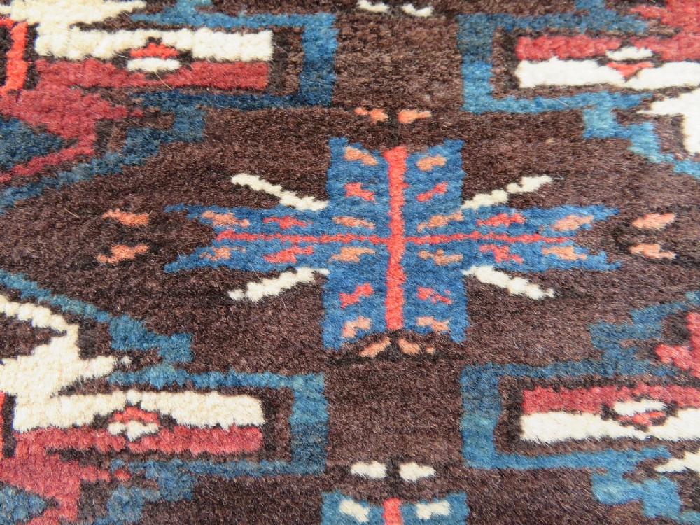 A rectangular hand-woven Yomut Turkmen wool chuval bag face featuring sixteen repeating central guls framed by geometric borders and a solid dark brown lower elem skirt. View XI