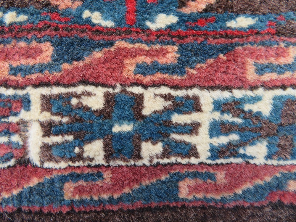 A rectangular hand-woven Yomut Turkmen wool chuval bag face featuring sixteen repeating central guls framed by geometric borders and a solid dark brown lower elem skirt. View XII