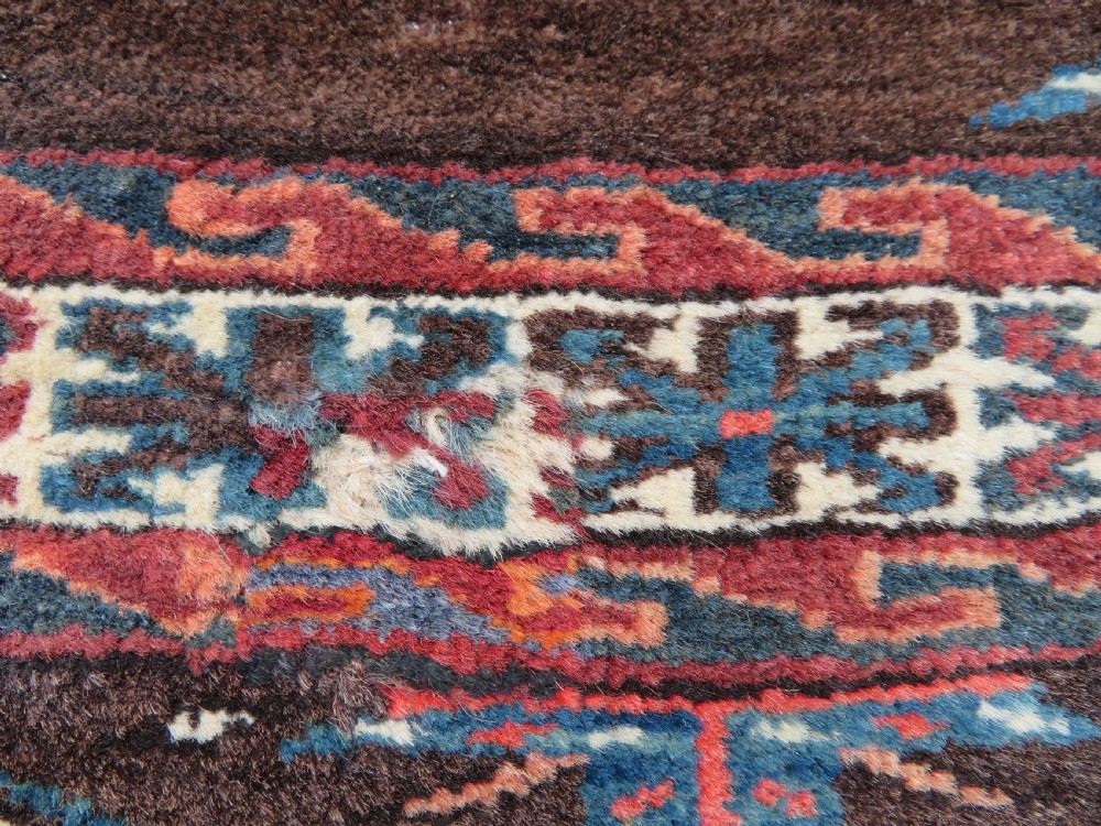 A rectangular hand-woven Yomut Turkmen wool chuval bag face featuring sixteen repeating central guls framed by geometric borders and a solid dark brown lower elem skirt. View XIV