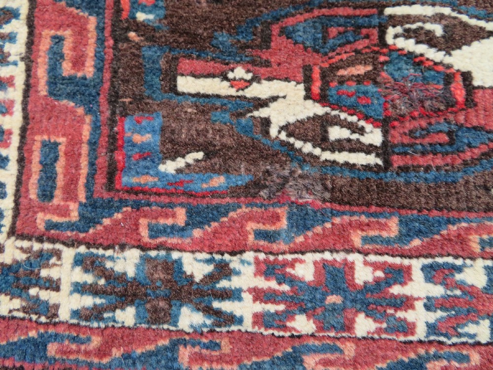 A rectangular hand-woven Yomut Turkmen wool chuval bag face featuring sixteen repeating central guls framed by geometric borders and a solid dark brown lower elem skirt. View XV