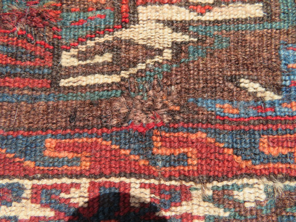 A rectangular hand-woven Yomut Turkmen wool chuval bag face featuring sixteen repeating central guls framed by geometric borders and a solid dark brown lower elem skirt. View XIX