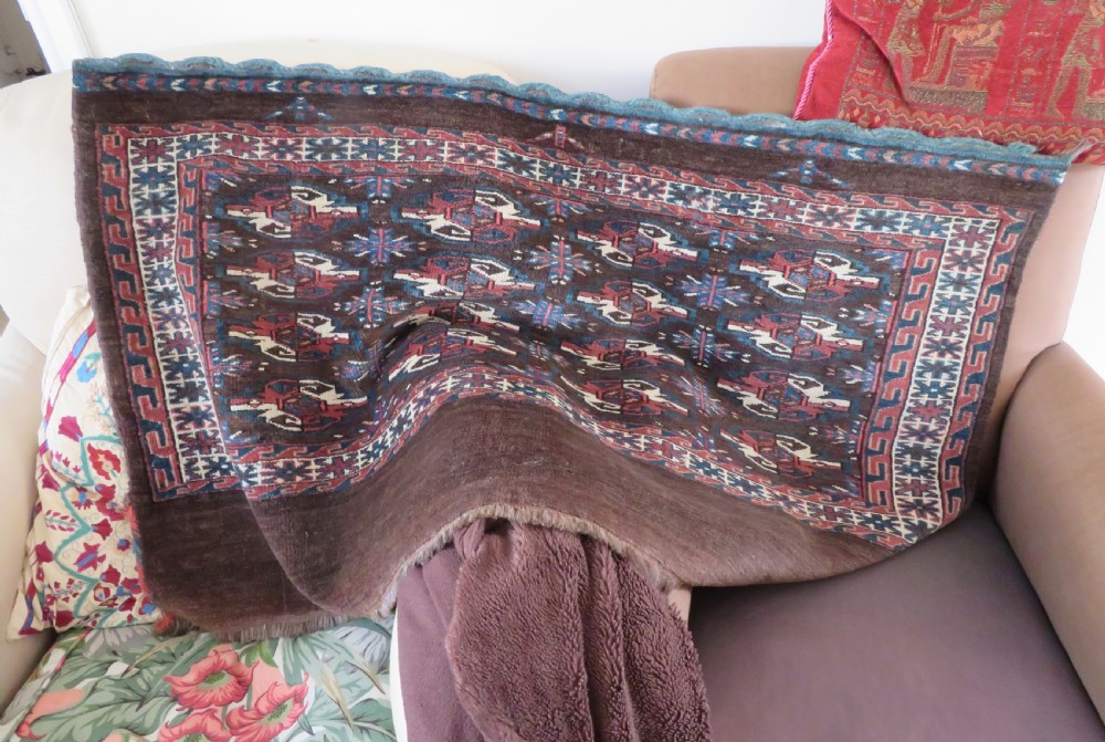 A rectangular hand-woven Yomut Turkmen wool chuval bag face featuring sixteen repeating central guls framed by geometric borders and a solid dark brown lower elem skirt. View XXI