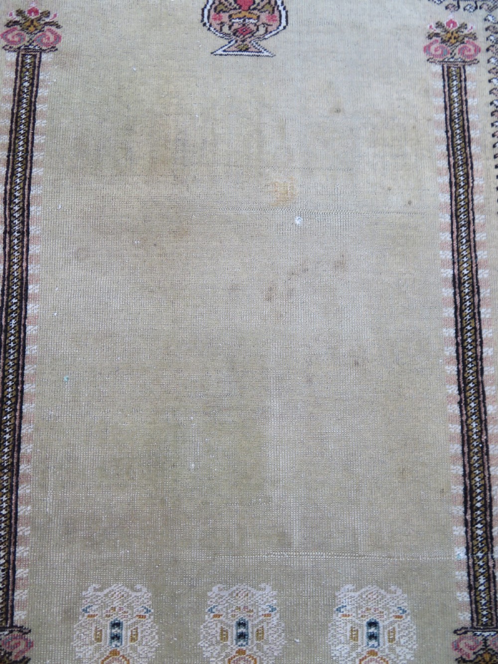 An antique Turkish Kayseri prayer rug featuring a central pale pistachio green field with a mihrab niche surrounded by intricate floral borders in coral pink and cream. View IX