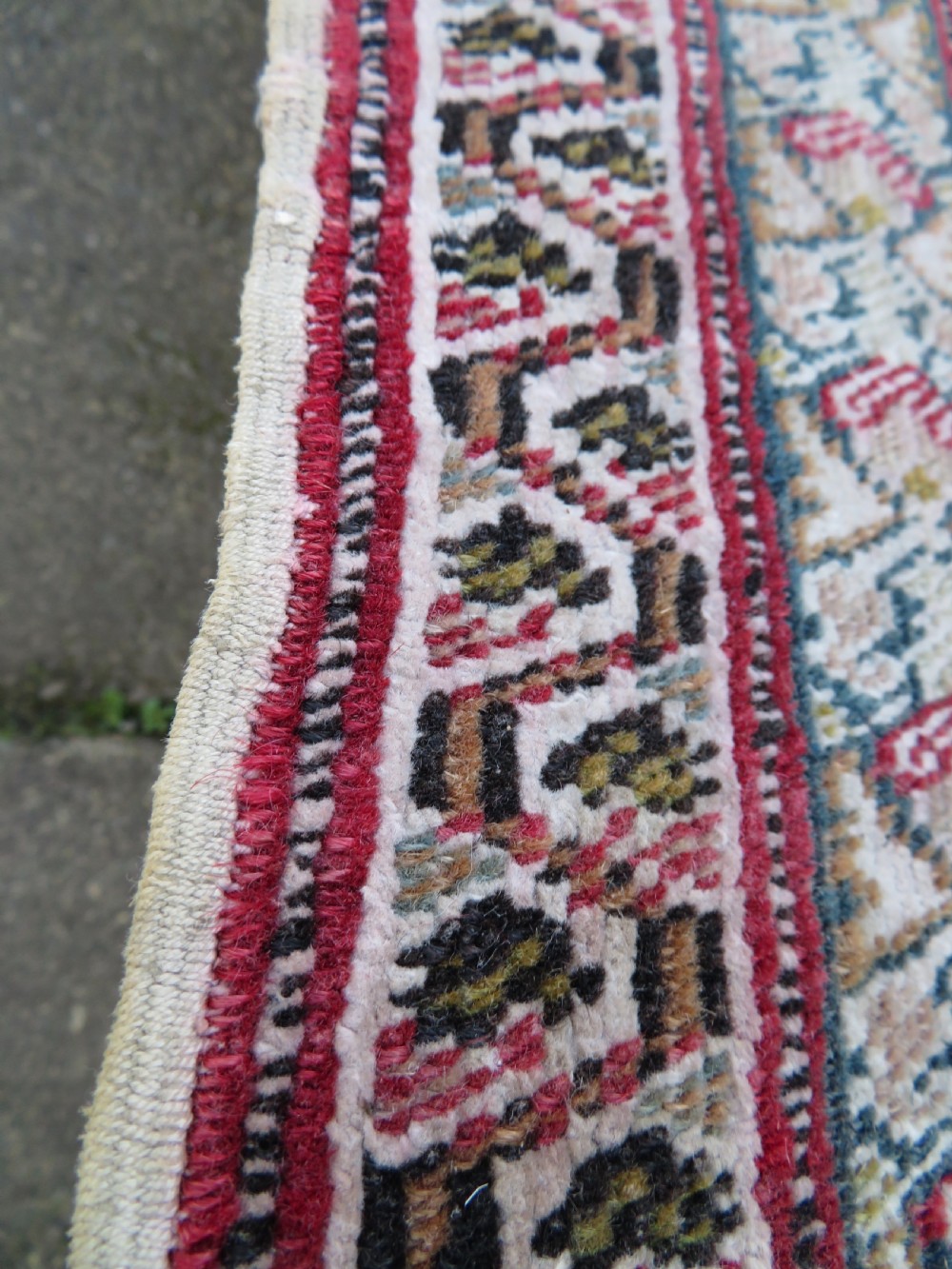 An antique Turkish Kayseri prayer rug featuring a central pale pistachio green field with a mihrab niche surrounded by intricate floral borders in coral pink and cream. View XV