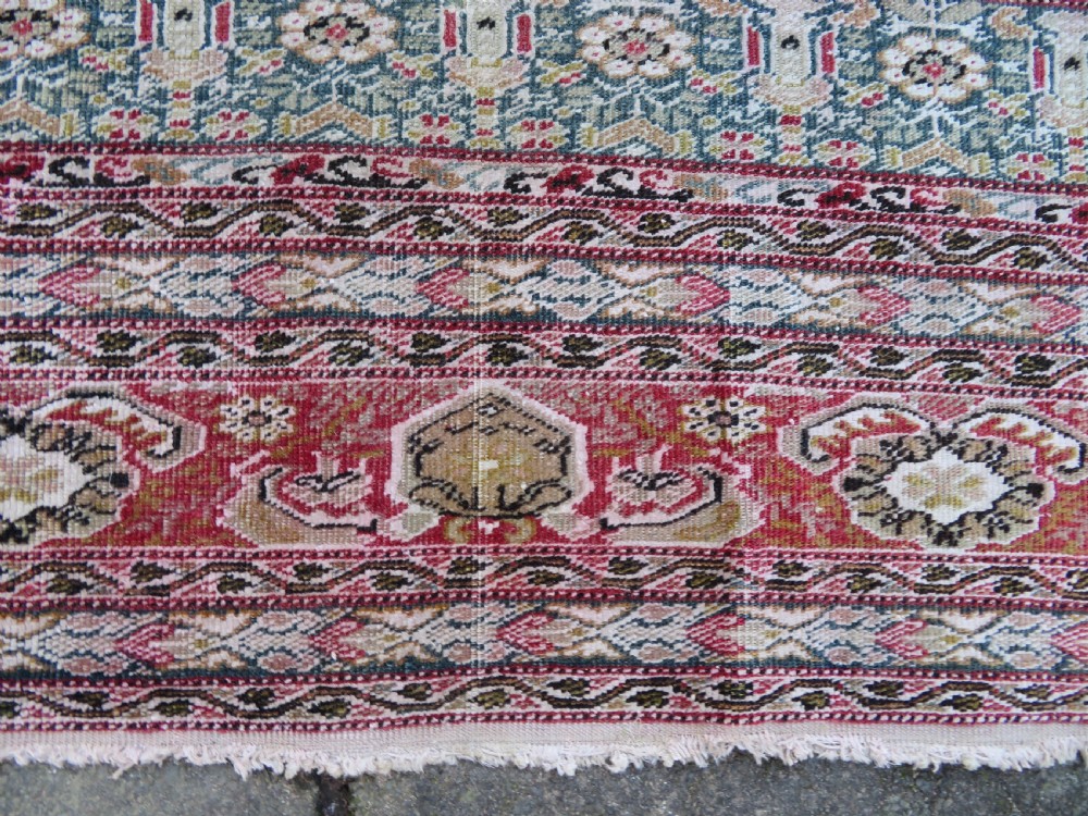 An antique Turkish Kayseri prayer rug featuring a central pale pistachio green field with a mihrab niche surrounded by intricate floral borders in coral pink and cream. View XVI