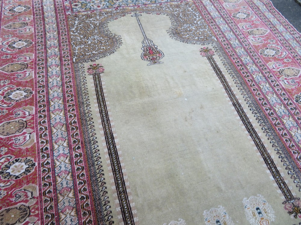 An antique Turkish Kayseri prayer rug featuring a central pale pistachio green field with a mihrab niche surrounded by intricate floral borders in coral pink and cream. View XX