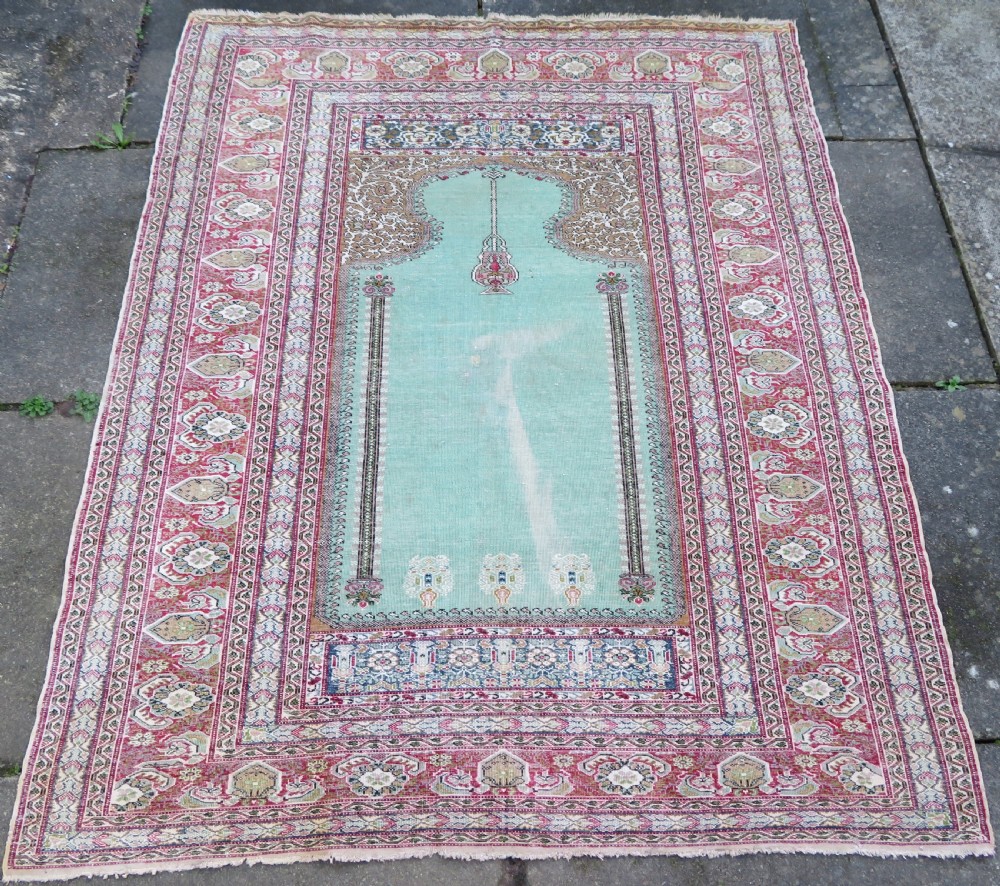 An antique Turkish Kayseri prayer rug featuring a central pale pistachio green field with a mihrab niche surrounded by intricate floral borders in coral pink and cream. View XXII