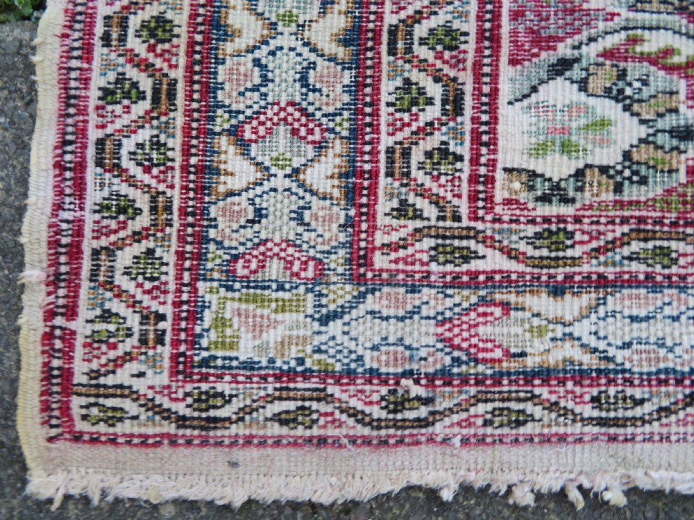 An antique Turkish Kayseri prayer rug featuring a central pale pistachio green field with a mihrab niche surrounded by intricate floral borders in coral pink and cream. View XXIII