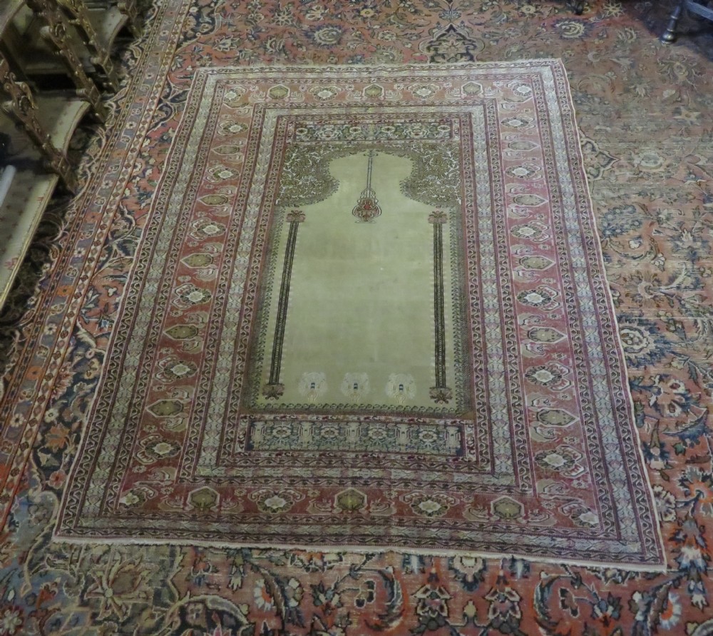 An antique Turkish Kayseri prayer rug featuring a central pale pistachio green field with a mihrab niche surrounded by intricate floral borders in coral pink and cream. View XXVII