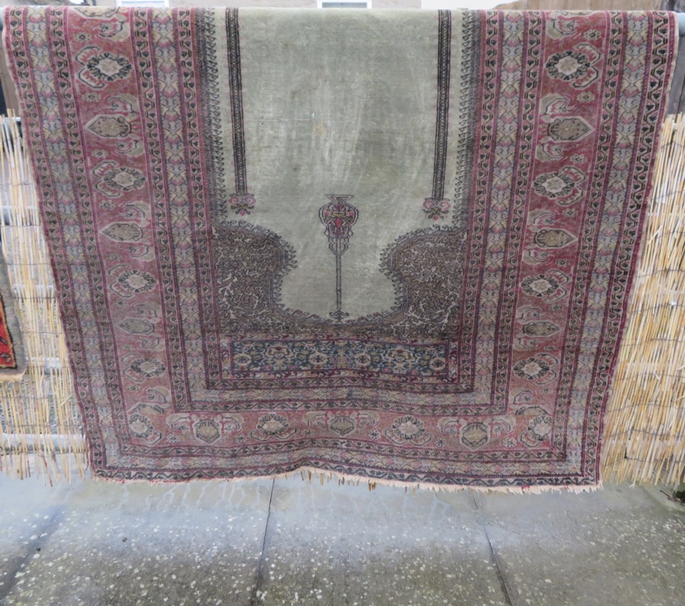 An antique Turkish Kayseri prayer rug featuring a central pale pistachio green field with a mihrab niche surrounded by intricate floral borders in coral pink and cream. View XXXI