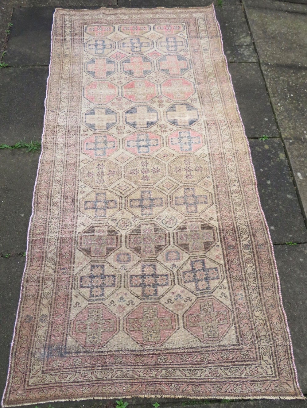 An antique Kurdish hand-knotted wool rug featuring octagonal geometric medallions, cross motifs, stylized animal figures, and a multi-banded border in rose, beige, and navy. View XXIII