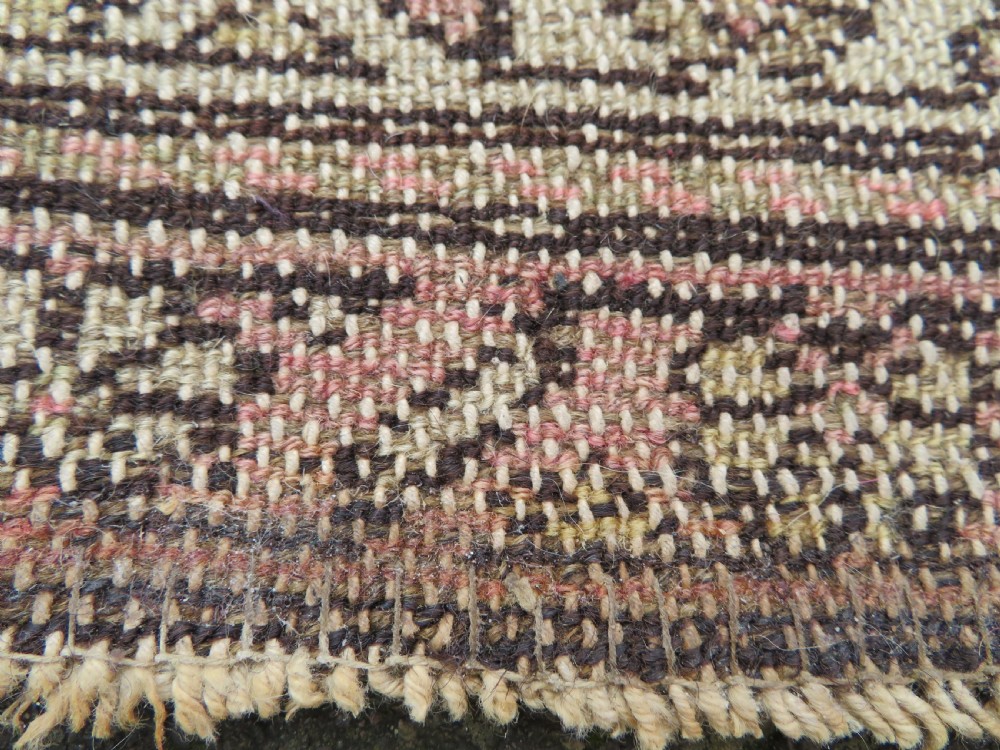An antique Kurdish hand-knotted wool rug featuring octagonal geometric medallions, cross motifs, stylized animal figures, and a multi-banded border in rose, beige, and navy. View XXIV