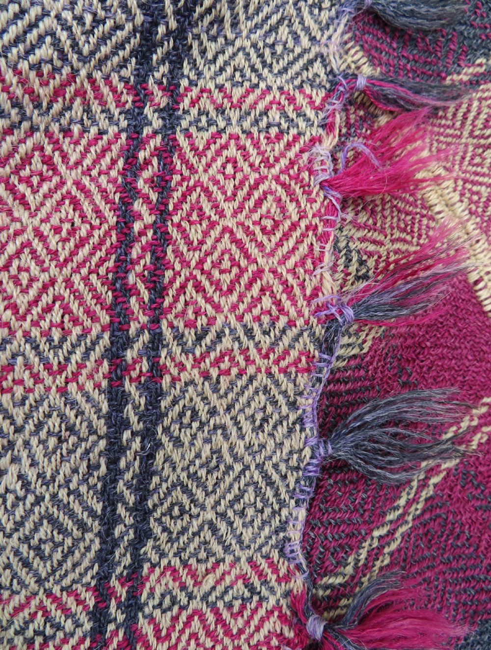 A rectangular flat-woven wool textile featuring crimson, navy, and cream geometric checked patterns with fringed ends. View XXI