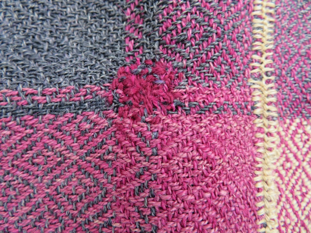 A rectangular flat-woven wool textile featuring crimson, navy, and cream geometric checked patterns with fringed ends. View XXIV