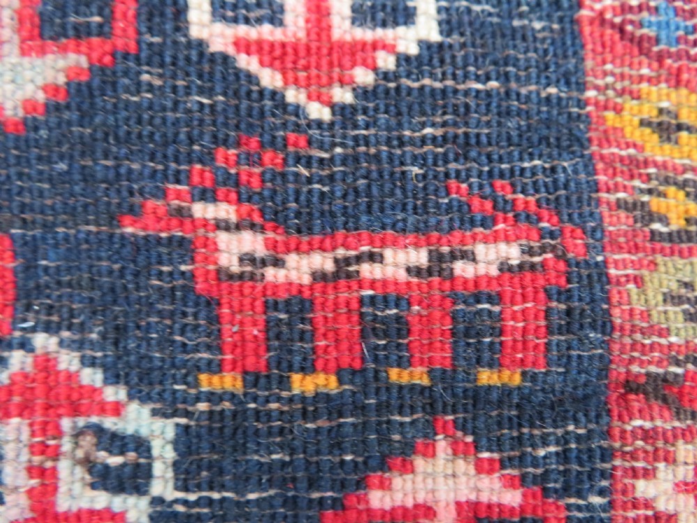 An antique late 19th-century Caucasian Kuba Konagkend wool rug featuring red geometric medallions set against a dark navy field with multi-coloured borders. View XXVI